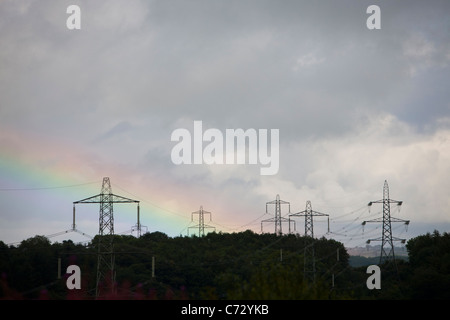 A rainbow over electricity pylons in North Wales. Stock Photo