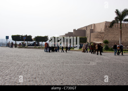 Tourists walking towards the Saladin Citadel. This is a wide open area near the parking location of the Citadel. Stock Photo