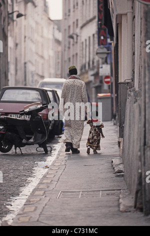 Immigrant father with child in the African Quarter, Barbes in the 18, 19e Arrondissement, Paris, France Stock Photo