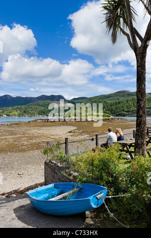 Couple looking out over Loch Carron from the terrace of a pub in the picturesque village of Plockton, Highland, Scotland, UK Stock Photo