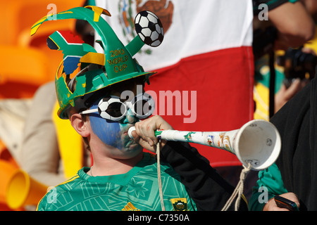 A young spectator blows a Vuvuzela at the opening match of the FIFA World Cup between South Africa and Mexico June 11, 2010. Stock Photo