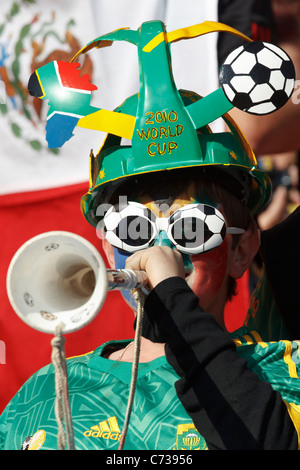 A young spectator blows a Vuvuzela at the opening match of the FIFA World Cup between South Africa and Mexico June 11, 2010. Stock Photo