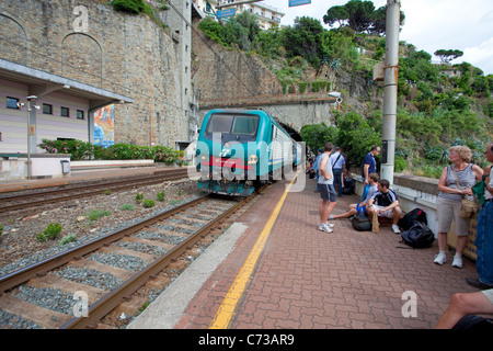 Train arrives at fishing village Riomaggiore, National park Cinque Terre, Unesco World Heritage site, Liguria di Levante, Italy, Mediterranean sea Stock Photo