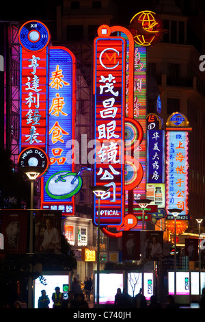 Neon signs above shops along Nanjing Road, Shanghai, China Stock Photo