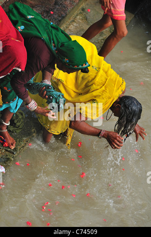 Pilgrims bathing at Har Ki Pairi ghat by the Ganges river 