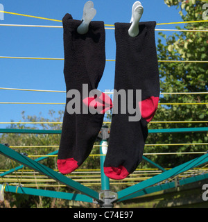 A Pair of Mens Socks Drying on a Washing Line Stock Photo