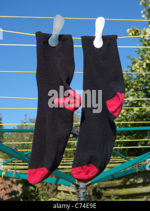 A Pair of Mens Socks Drying on a Washing Line Stock Photo