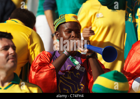 A spectator blows a Vuvuzela at the opening match of the FIFA World Cup between South Africa and Mexico June 11, 2010. Stock Photo