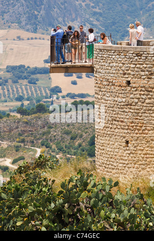 Tourists on lookout point admiring view. Ronda, Malaga Province, Spain. Stock Photo
