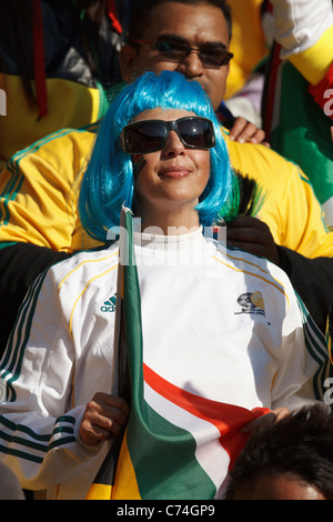 Female South African football supporter shouting and clutching a World