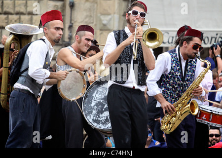 Festival: Men Masked Like Indian Musicians Playing Flute And Braggart 