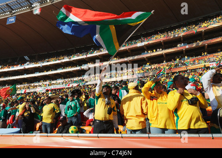A South Africa supporter waves the national flag at the opening match of the 2010 FIFA World Cup between South Africa and Mexico Stock Photo