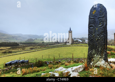Cross pillar and St. Columba's Church, Glencolmcille, County Donegal, Republic of Ireland Stock Photo