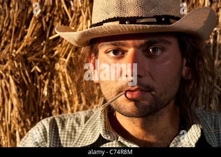 Farmer With Cowbabe Hat And Wheat Straw In His Mouth Stock Photo Alamy