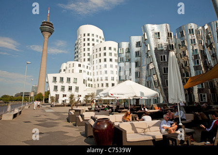 The Neue Zollhof  designed by  architect Frank O. Gehry of Media Harbor and Rheinturm telecommunications tower in Duesseldorf, Stock Photo