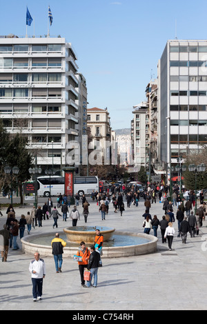 Athenians walking in Syntagma Square (Constitution Square, opposite Hellenic Parliament) Stock Photo