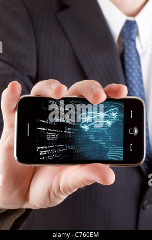 Businessman showing us a touch phone with a network related theme. Stock Photo