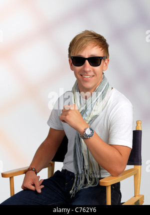 Handsome young man posing as a film director Stock Photo