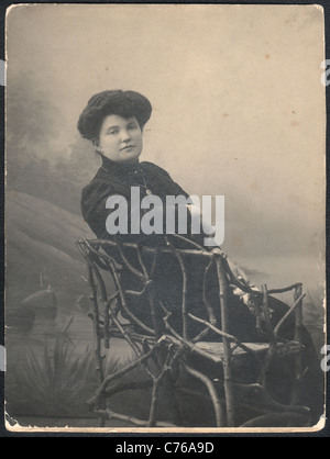 Portrait of a woman in a wicker chair, circa 1890-1910 Stock Photo