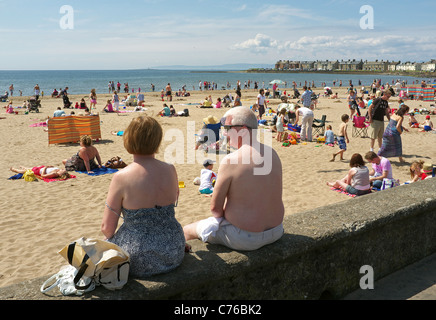 People sunbathing on the beach at Troon, Ayrshire, Scotland, UK, Great Britain Stock Photo