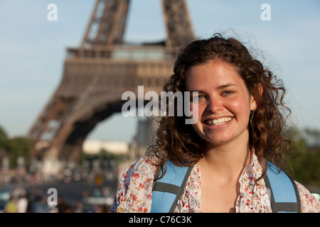 France, Paris, Portrait of young woman in front of Eiffel Tower Stock Photo