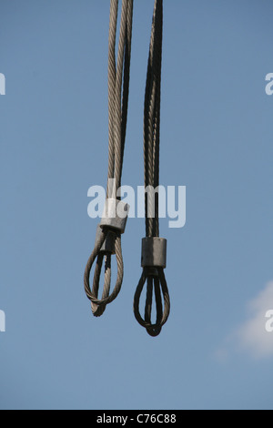 Metal steel wires hanging in blue sky Stock Photo