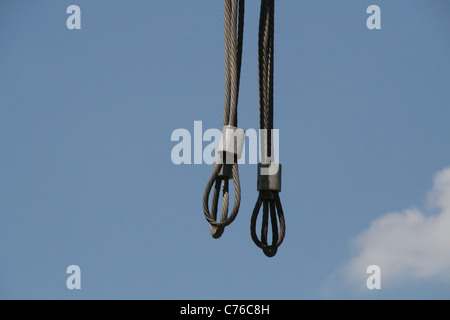 Metal steel wires hanging in blue Stock Photo