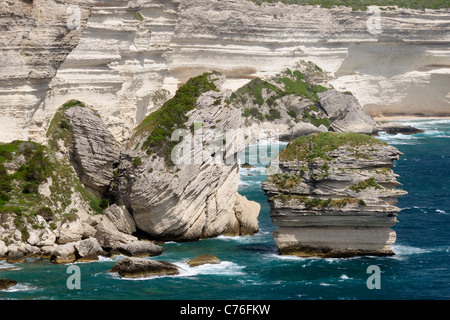 White limestone cliffs and sectionscollapsed into the sea, including 'le grain de sable' (grain of sand) sea stack, Corsica. Stock Photo
