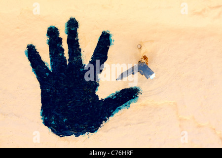 Blue handprint and tail of a fish - a symbol of good luck and prosperity elusive in the Berber people and Tunisians Stock Photo