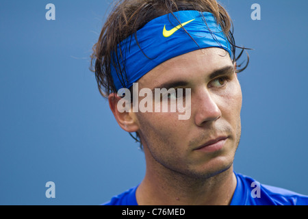 Portrait of Spanish tennis player Rafael Nadal tying headband