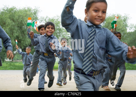 School boys running with the Indian flag Stock Photo