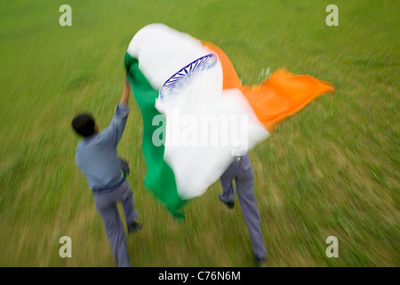 School boys running with the Indian flag Stock Photo