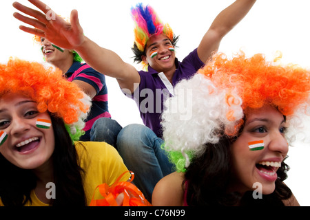 Youngsters with wigs cheering Stock Photo