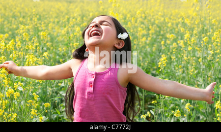 Young girl enjoying herself in a field Stock Photo