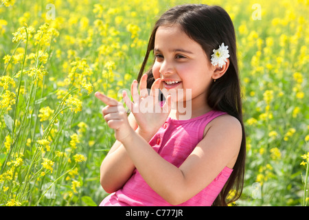 Young girl having fun in a field Stock Photo