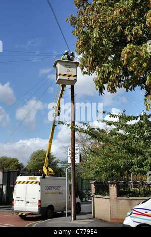 UK Openreach telephone engineer working on pole using van hydraulic lift Stock Photo