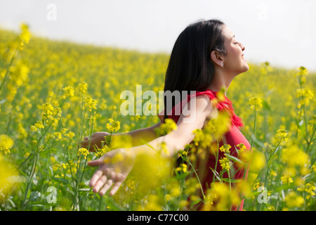 Young woman enjoying herself in a field Stock Photo