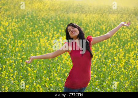 Young woman enjoying herself in a field Stock Photo