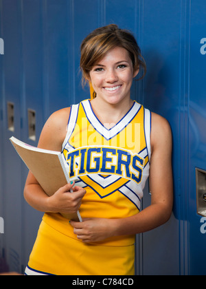 USA, Utah, Spanish Fork, Portrait of school girl (16-17) holding notepad by lockers Stock Photo