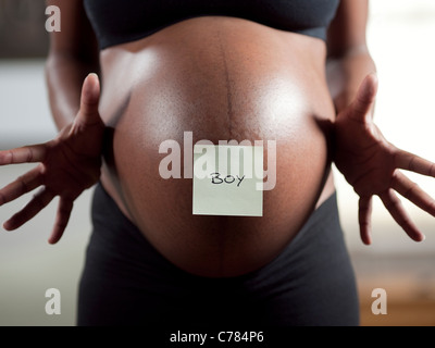 USA, Utah, Orem, Pregnant woman with adhesive note on belly Stock Photo