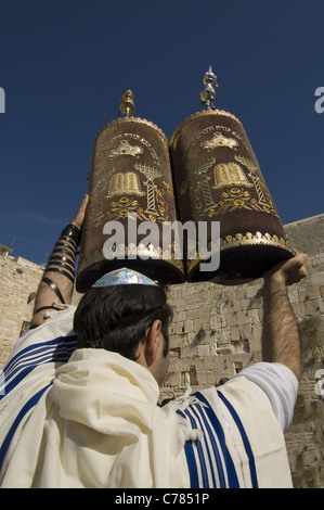 Orthodox Jew wrapped with Talit ( prayer shawl ) holding Torah sacred scrolls at the Western Wall East Jerusalem Israel Stock Photo