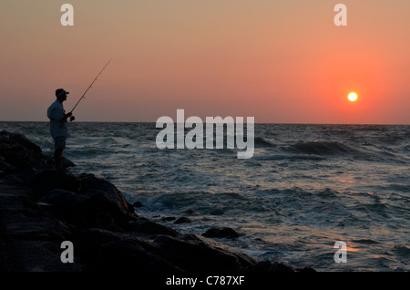 Fishing at sunset over the Gulf of Mexico Stock Photo