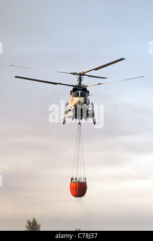 Kamov Ka-32A11BC helicopter carrying water for fire, Cabopino Golf, Costa del Sol, Malaga Province, Andalucia, Spain, Europe. Stock Photo