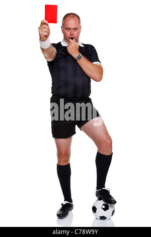 Full length photo of a football or soccer referee showing you the red card for a sending off, isolated on a white background. Stock Photo