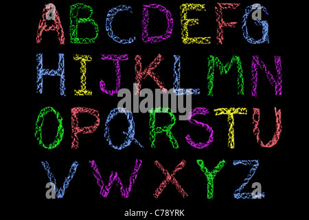 Handwritten letters of the alphabet written on a blackboard in white chalk then cleaned up during editing Stock Photo