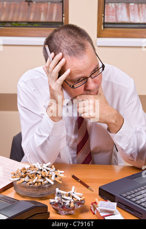 Worried businessman with cigarette Stock Photo