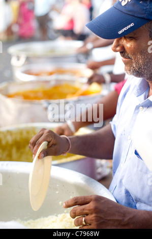 A man was serving free vegetarian food during Thaipusam festival in Penang, Malaysia. Stock Photo