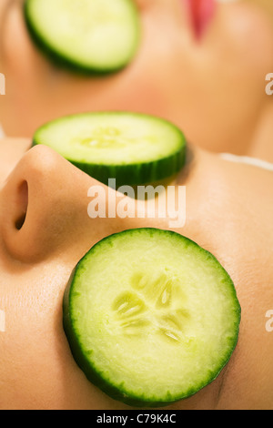 Girls in a beauty treatment with cucumber slices Stock Photo