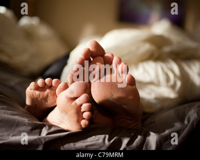 USA, Utah, Provo, Close-up of feet of couple lying in bed Stock Photo
