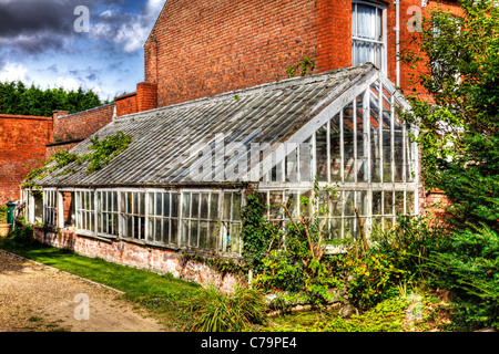 Louth, Lincolnshire, England, old victorian greenhouse derelict and overgrown huge massive structure left to rot Stock Photo